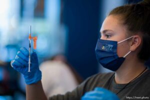 (Trent Nelson  |  The Salt Lake Tribune) Claire Quick administers COVID-19 vaccinations at Vivint Arena in Salt Lake City on Friday, Oct. 29, 2021. University of Utah Health and the Utah Jazz held the community vaccination clinic, giving two free Jazz tickets to a future game for the first 50 individuals receiving a vaccine shot.