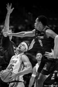 (Trent Nelson  |  The Salt Lake Tribune) Utah Utes guard Rollie Worster (25) drives under Westminster Griffins forward Zach Scott (33) and Westminster Griffins guard Quincy Bair (11) as the Utah Utes host the Westminster Griffins, NCAA basketball in Salt Lake City on Thursday, Nov. 4, 2021.