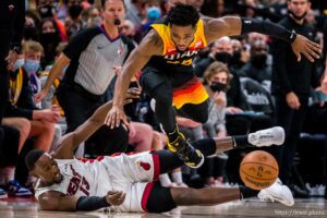 (Trent Nelson  |  The Salt Lake Tribune) Utah Jazz guard Donovan Mitchell (45) leaps over Miami Heat center Bam Adebayo (13) in pursuit of a loose ball as the Utah Jazz host the Miami Heat, NBA basketball in Salt Lake City on Saturday, Nov. 13, 2021.