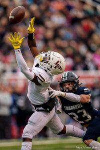 (Trent Nelson  |  The Salt Lake Tribune) Lone Peak's Luke Hyde (2) comes up just short of the catch as Lone Peak faces Corner Canyon in the 6A high school football championship game in Salt Lake City on Friday, Nov. 19, 2021. Defending is Corner Canyon's Aiden McDonald (23).