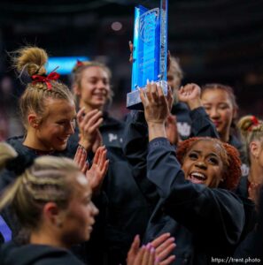 (Trent Nelson  |  The Salt Lake Tribune) Utah celebrates with the Pac-12 championship trophy at the Pac-12 gymnastics championships at the Maverik Center in West Valley City on Saturday, March 19, 2022.