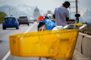 (Trent Nelson  |  The Salt Lake Tribune) A man and his belongings on the side of Victory Road road as camps are cleared in the foothills north of Salt Lake City on Wednesday, April 27, 2022.