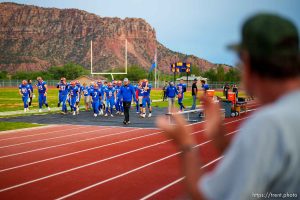 (Trent Nelson  |  The Salt Lake Tribune) Down 0-40 at halftime of their first-ever football game, Water Canyon High School football players are applauded by fans in Hildale on Friday, Aug. 12, 2022.
