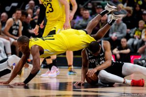 (Trent Nelson  |  The Salt Lake Tribune) Utah Jazz guard Kris Dunn (11) flies over San Antonio Spurs guard Malaki Branham (22) as the Utah Jazz host the San Antonio Spurs, NBA basketball in Salt Lake City on Tuesday, Feb. 28, 2023.