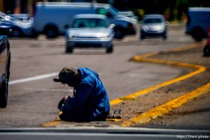 man sitting in the street, Salt Lake City, Tuesday July 11, 2023.