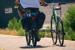 Man with two bikes, Salt Lake City on Wednesday, July 10, 2024.