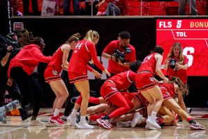 (Trent Nelson  |  The Salt Lake Tribune) Utah players dogpile on Utah Utes guard Matyson Wilke (23) after her game-winning shot as Utah hosts BYU, NCAA basketball in Salt Lake City on Saturday, March 1, 2025.