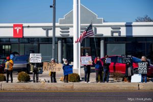 (Trent Nelson  |  The Salt Lake Tribune) People protest Elon Musk and DOGE at the South Salt Lake Tesla dealership on Saturday, March 1, 2025.