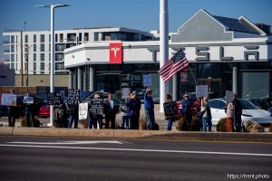 (Trent Nelson  |  The Salt Lake Tribune) People protest Elon Musk and DOGE at the South Salt Lake Tesla dealership on Saturday, March 1, 2025.