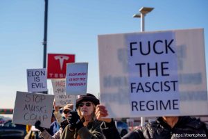 (Trent Nelson  |  The Salt Lake Tribune) People protest Elon Musk and DOGE at the South Salt Lake Tesla dealership on Saturday, March 1, 2025.