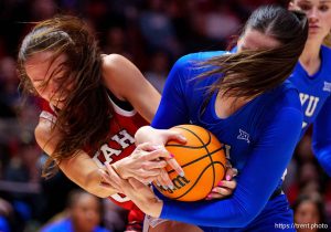 (Trent Nelson  |  The Salt Lake Tribune) Utah Utes forward Jenna Johnson (22) and BYU Cougars forward Emma Calvert (25) as Utah hosts BYU, NCAA basketball in Salt Lake City on Saturday, March 1, 2025.