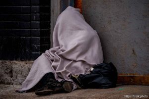 (Trent Nelson  |  The Salt Lake Tribune) A person experiencing homelessness on the sidewalk along State Street in Salt Lake City on Wednesday, March 5, 2025.