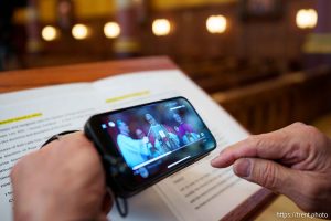 (Trent Nelson  |  The Salt Lake Tribune) Bishop Oscar Solis listens to the blessing of Pope Leo XIV, streamed from his phone, at the Cathedral of the Madeleine in Salt Lake City on Thursday, May 8, 2025.