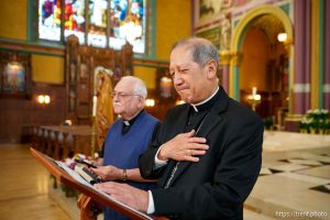 (Trent Nelson  |  The Salt Lake Tribune) Bishop Oscar Solis listens to the blessing of Pope Leo XIV, streamed from his phone, at the Cathedral of the Madeleine in Salt Lake City on Thursday, May 8, 2025. At left is Father Martin Diaz, rector of the Cathedral of the Madeleine.