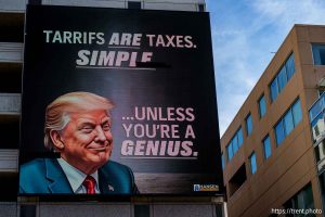 tarrifs are taxes. simple...unless you're a genius. donald trump on downtown electronic billboard in Salt Lake City on Monday, June 2, 2025.