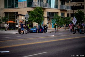 (Trent Nelson | The Salt Lake Tribune) A man lays injured on the street as police respond to a reported shooting during 'No Kings' protest march in Salt Lake City, Saturday, June 14, 2025. (full sequence, not initial select)