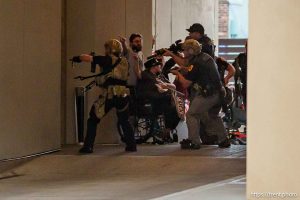 (Trent Nelson | The Salt Lake Tribune) A man lays injured on the street as police respond to a reported shooting during a protest march in Salt Lake City, Saturday, June 14, 2025.