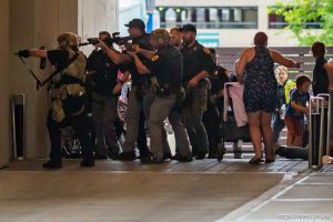 (Trent Nelson | The Salt Lake Tribune) A man lays injured on the street as police respond to a reported shooting during a protest march in Salt Lake City, Saturday, June 14, 2025.