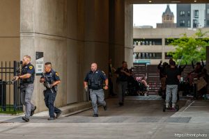 (Trent Nelson | The Salt Lake Tribune) A man lays injured on the street as police respond to a reported shooting during a protest march in Salt Lake City, Saturday, June 14, 2025.