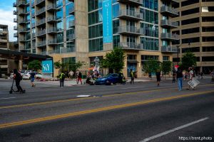 (Trent Nelson | The Salt Lake Tribune) A man lays injured on the street as police respond to a reported shooting during a protest march in Salt Lake City, Saturday, June 14, 2025.