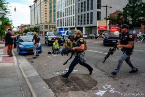(Trent Nelson | The Salt Lake Tribune) A man lays injured on the street as police respond to a reported shooting during a protest march in Salt Lake City, Saturday, June 14, 2025.