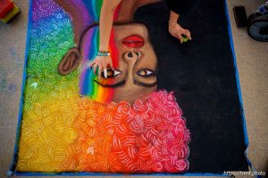 (Trent Nelson  |  The Salt Lake Tribune) Elena Aguilar works on chalk art at West Valley Pride, held at the Utah Cultural Celebration Center in West Valley City on Thursday, June 26, 2025.