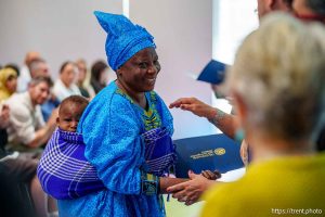 (Trent Nelson  |  The Salt Lake Tribune) Saverina Ntamukunzi receives her certificate of citizenship while carrying her grandchild Issa Mechak Merci at a naturalization ceremony in Kearns on Tuesday, Aug. 5, 2025.