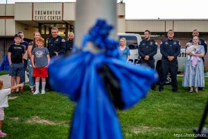 (Trent Nelson  |  The Salt Lake Tribune) Police officers and family members at a vigil in Tremonton on Tuesday, Aug. 19, 2025 to honor two city police officers who were killed and a sheriff’s deputy who was wounded two days earlier in a shooting.