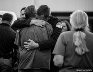(Trent Nelson  |  The Salt Lake Tribune) Police officers and family members at a vigil in Tremonton on Tuesday, Aug. 19, 2025 to honor two city police officers who were killed and a sheriff’s deputy who was wounded two days earlier in a shooting.