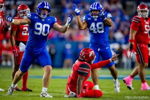 (Trent Nelson  |  The Salt Lake Tribune) BYU Cougars defensive end Hunter Clegg (90) celebrates sacking Utah Utes quarterback Devon Dampier (4) as BYU hosts Utah, NCAA football at LaVell Edwards Stadium in Provo on Saturday, Oct. 18, 2025. At right is Utah Utes defensive end Alex Cloward (48).