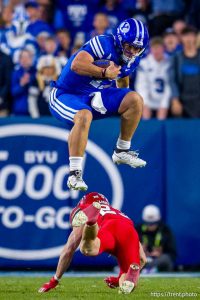 (Trent Nelson  |  The Salt Lake Tribune) BYU Cougars quarterback Bear Bachmeier (47) leaps over Utah Utes safety Jackson Bennee (23) as BYU hosts Utah, NCAA football at LaVell Edwards Stadium in Provo on Saturday, Oct. 18, 2025.