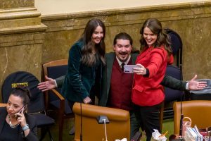 (Trent Nelson  |  The Salt Lake Tribune) Rep. Ariel Defay, R-Kaysville, Rep. Grant Miller, D-Salt Lake City, and Rep. Sahara Hayes, D-Millcreek, take a selfie before a special session on redistricting and the anti-public union bill at the Utah Capitol in Salt Lake City on Tuesday, Dec. 9, 2025.