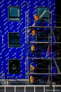 (Trent Nelson  |  The Salt Lake Tribune) Workers disassemble scaffolding during the construction of a new apartment complex in Salt Lake City on Monday, Dec. 29, 2025.