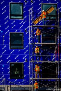 (Trent Nelson  |  The Salt Lake Tribune) Workers disassemble scaffolding during the construction of a new apartment complex in Salt Lake City on Monday, Dec. 29, 2025.